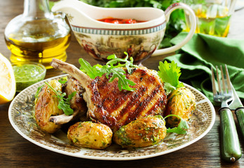 Grilled pork chop on the bone with spicy potatoes.  