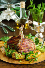 Grilled pork chop on the bone with spicy potatoes.  