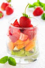 Fruit salad of strawberries, kiwis and apricots.