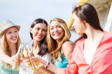 girls with drinks on the beach