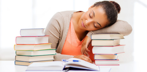 tired student with books and notes