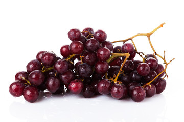Fresh red grapes and water drops isolated on white background
