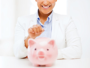 woman with piggy bank and coin