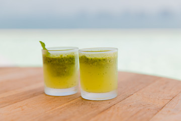 glasses of fresh juice or cocktail on beach