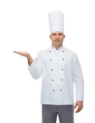 happy male chef cook showing empty palm