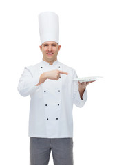 happy male chef cook showing empty plate