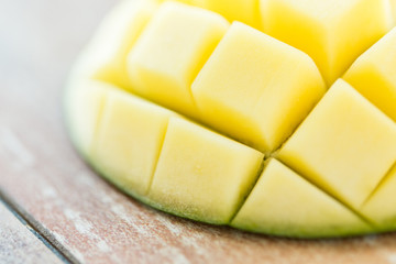 close up of ripe mango slice on table