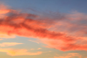 Sunset in the sky covered with red clouds