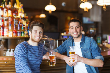 happy male friends drinking beer at bar or pub