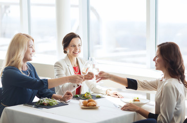 happy women drinking champagne at restaurant