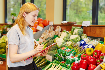 Woman in supermarket making apprenticeship