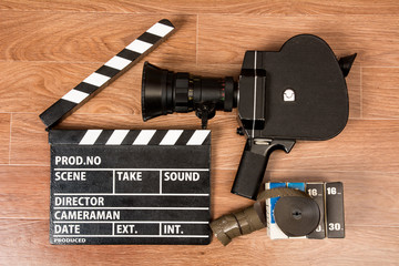 Fototapeta premium Old movie camera with a movie clapper and film.