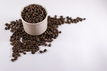 Roasted Coffee Beans Inside a Cup with Copyspace on White Cardbo