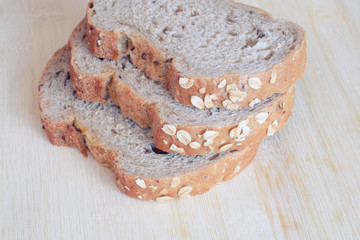 Whole wheat bread on wooden background