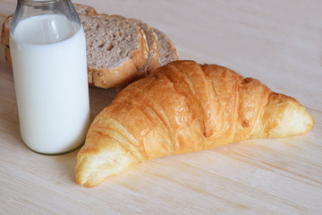 Breakfast set with whole wheat bread milk and croissant