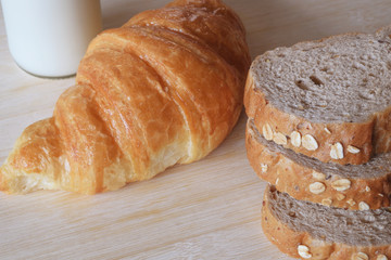 Breakfast set with whole wheat bread milk and croissant