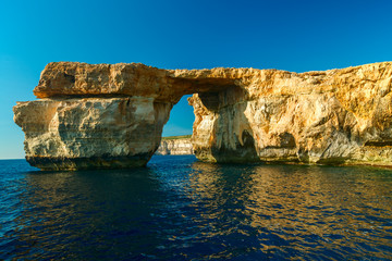 Azure Window, famous stone arch on Gozo island with reflection,