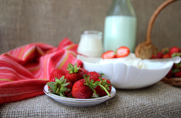 Dish of cottage cheese with cream and strawberries,