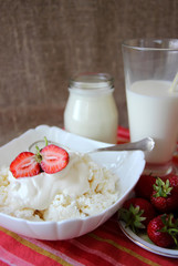 Dish of cottage cheese with cream and strawberries,