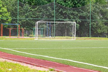 Football goal on a green field on a background