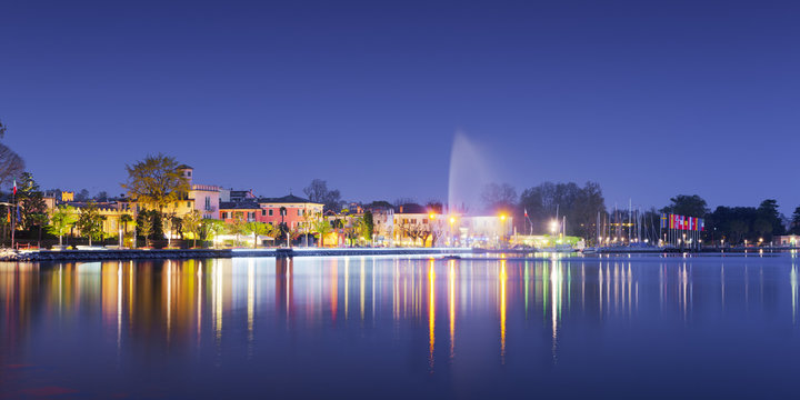 beach of city bardolino with reflections in lake at night