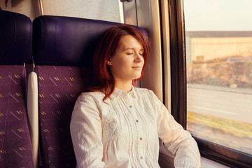 Traveling Train Comfort -Young woman feeling relaxed 
