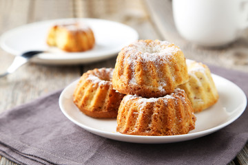 Bundt cakes on plate on grey wooden background