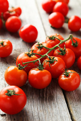 Fresh cherry tomatoes on grey wooden background
