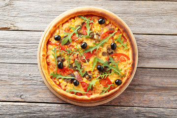 Fresh tasty pizza on grey wooden background