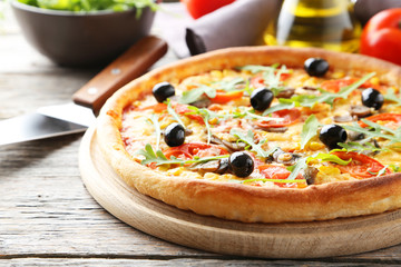 Fresh tasty pizza on grey wooden background