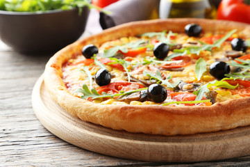 Fresh tasty pizza on grey wooden background