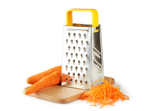 Metal grater and carrot isolated on white