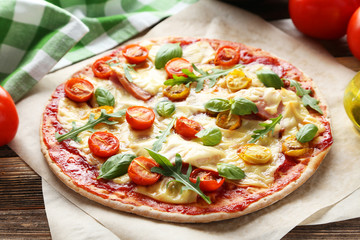 Fresh tasty pizza on brown wooden background
