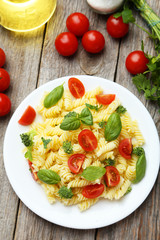 Delicious pasta on plate on grey wooden background