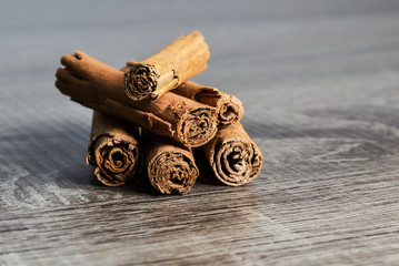 Cinnamon sticks isolated on brown wooden background
