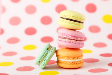 French macarons on colorful background