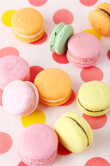 French macarons on colorful background