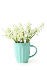 Lily of the Valley in cup on white background