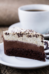 Chocolate dessert with coffee cup and coffee beans on wooden bac