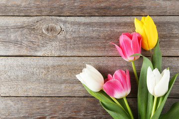 Beautiful tulips on grey wooden background