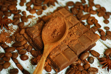 Still life with chocolate, grains and spice on wooden table, closeup