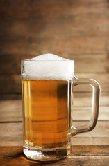 Glass of beer on wooden background