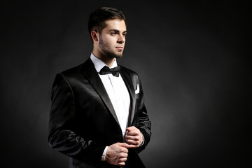 Elegant man in suit on dark background