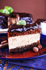 Delicious chocolate cake with icing in plate on table, closeup