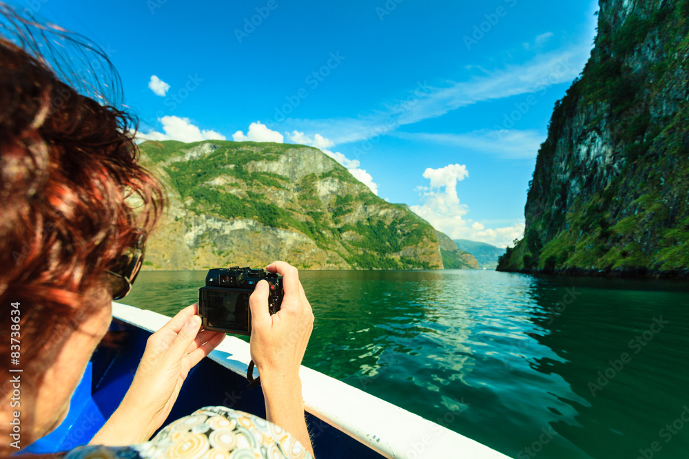 Sticker tourism. woman with camera on ship, fjord in norway.