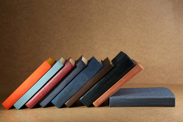 Old books on shelf, close-up, on wooden background