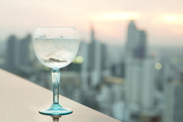 Gin tonic cocktail on table in rooftop bar