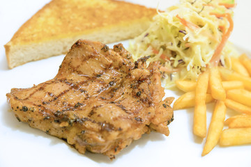 Chicken steak served with french fries ,salads and bread