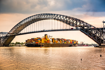 Cargo ship passes under Bayonne Bridge, NJ - obrazy, fototapety, plakaty