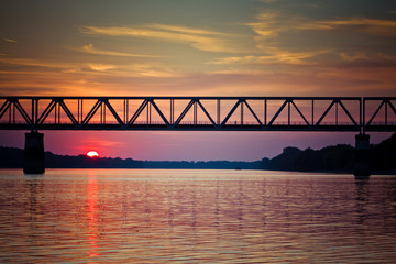 Fototapeta premium Sunset on the river with bridge.